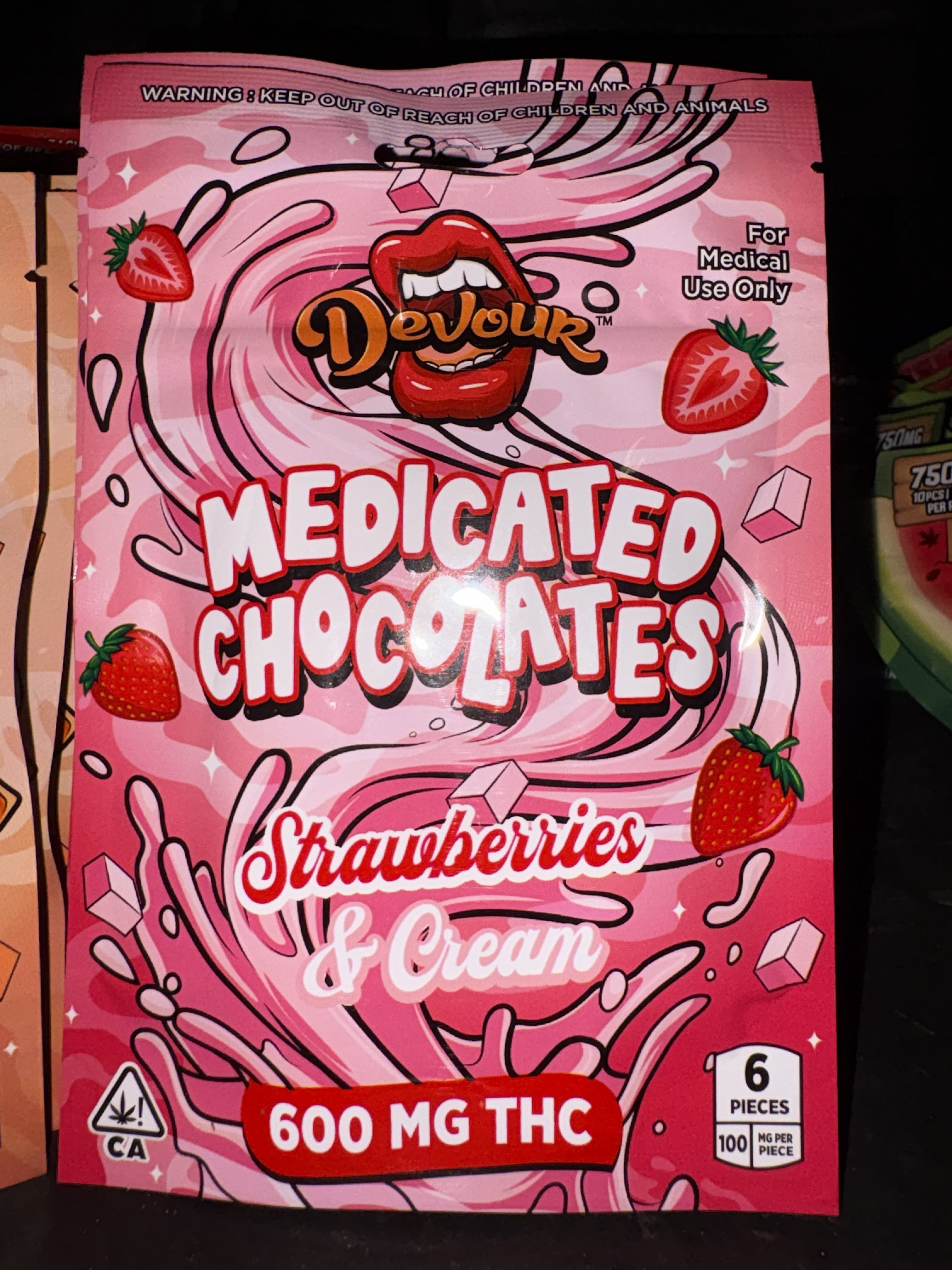Pink packaging for Devour Medicated Chocolates, Strawberries and Cream flavor, containing 600mg of THC.
