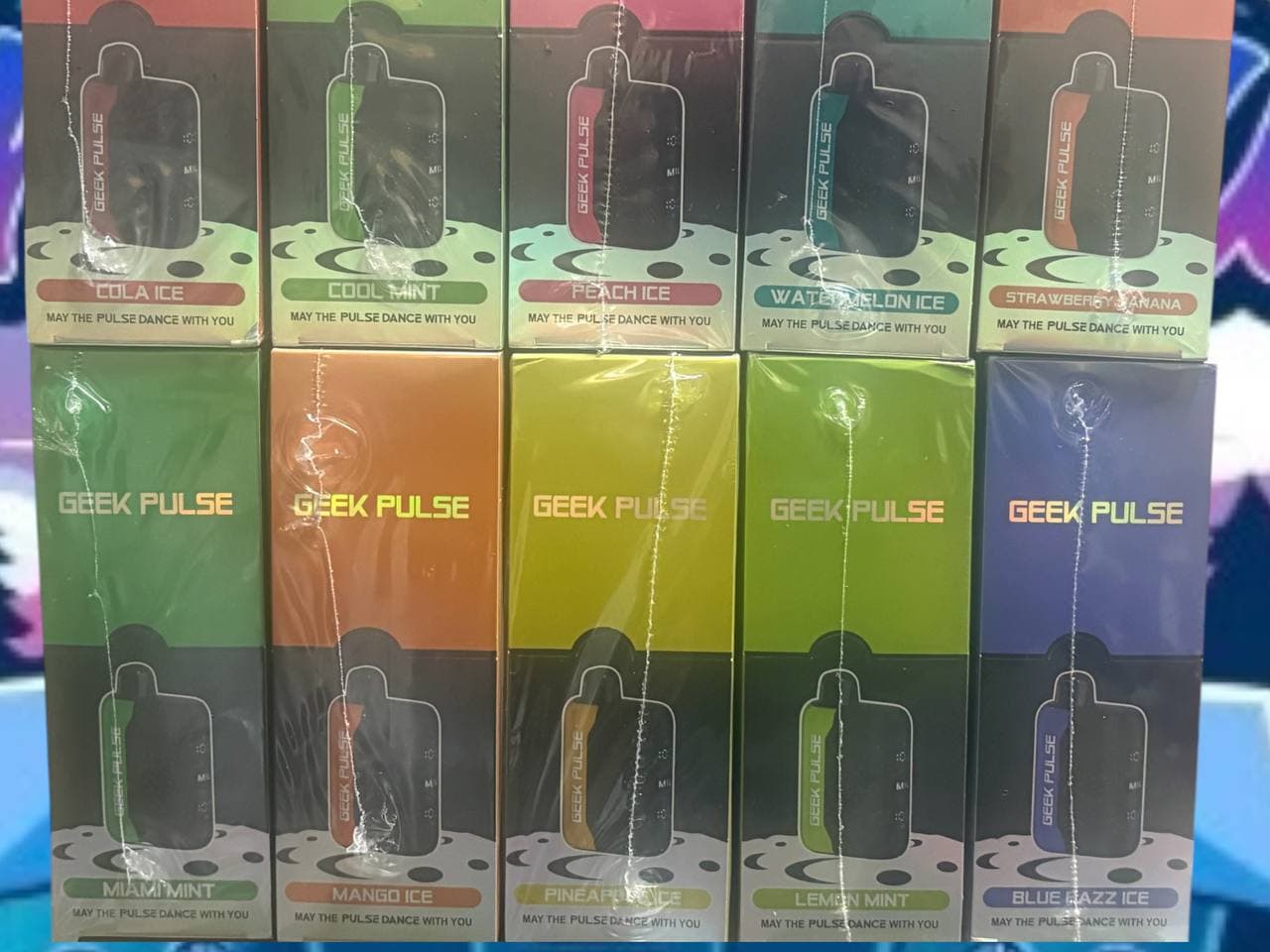 Ten colorful Geek Pulse disposable vape boxes in various flavors arranged in two rows.