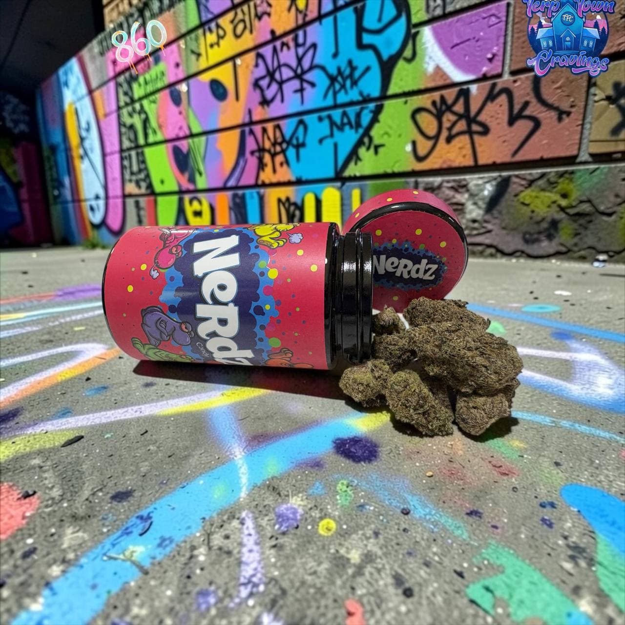 Cannabis buds spilling from a pink Nerdz jar onto a colorful, graffiti-covered sidewalk.